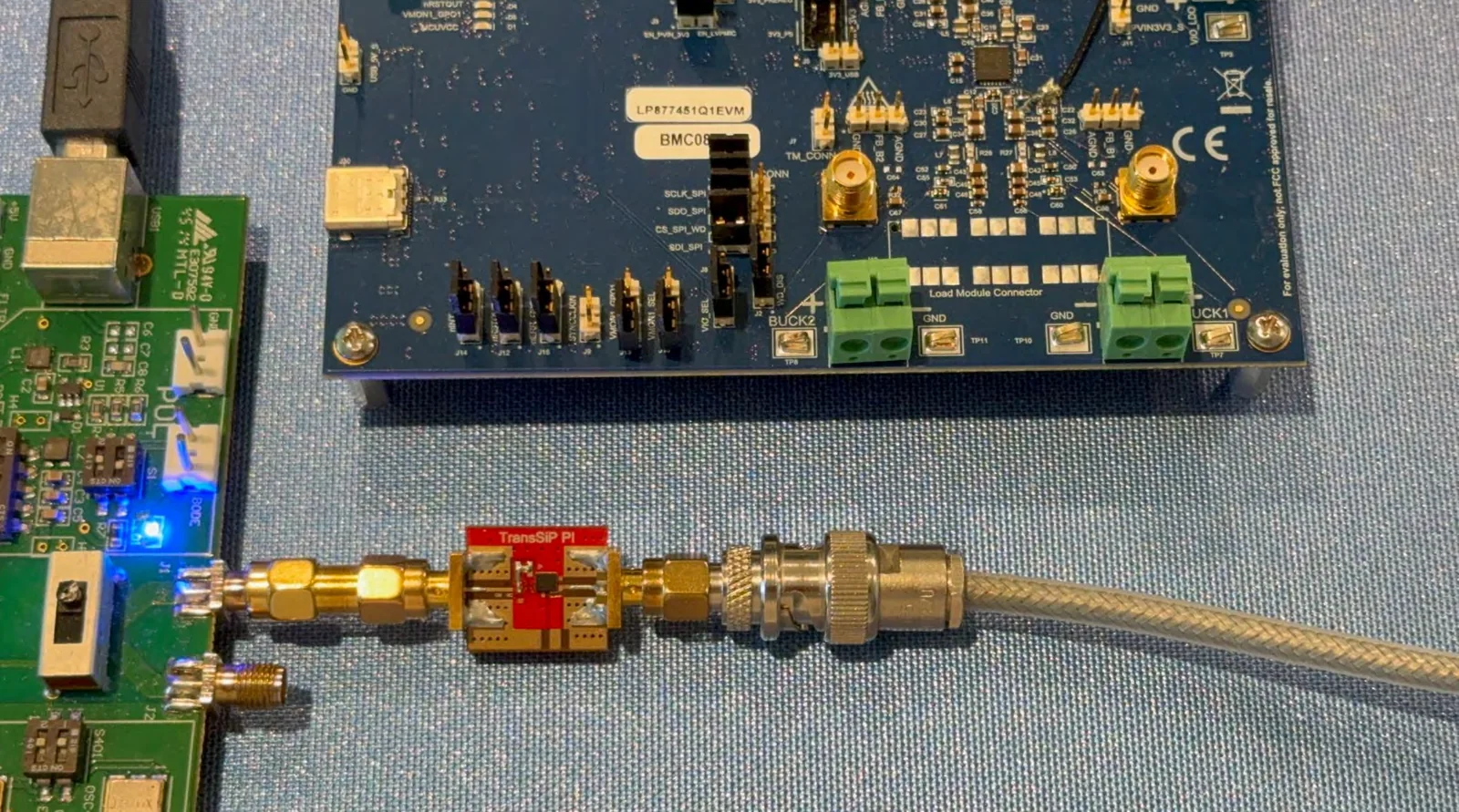 A Picotest VRTS3 board feeding a red Harmony Type-B evaluation board through SMA adapters into a coaxial cable